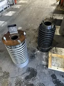 Comparison of failed and new boiler coil from industrial hot pressure washer during emergency repair in Atherstone.